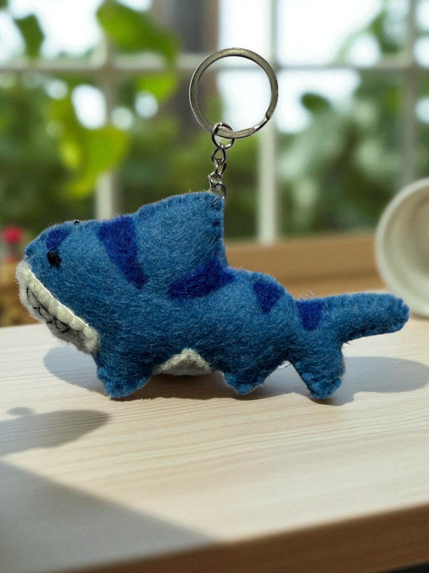 Handmade felt keychain featuring a shark by artisans in Nepal, fair trade and eco-friendly