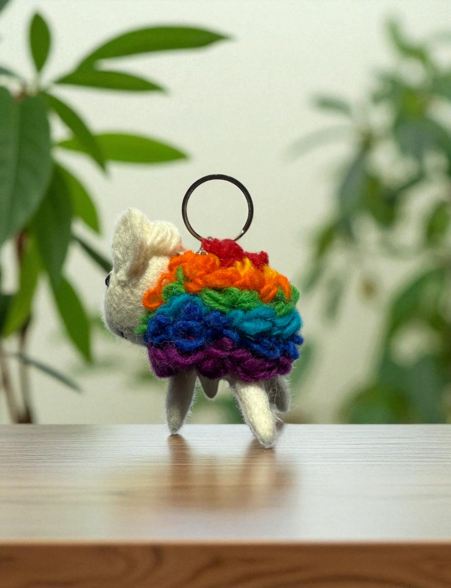 Handmade felt keychain featuring a rainbow sheep by artisans in Nepal, fair trade and eco-friendly