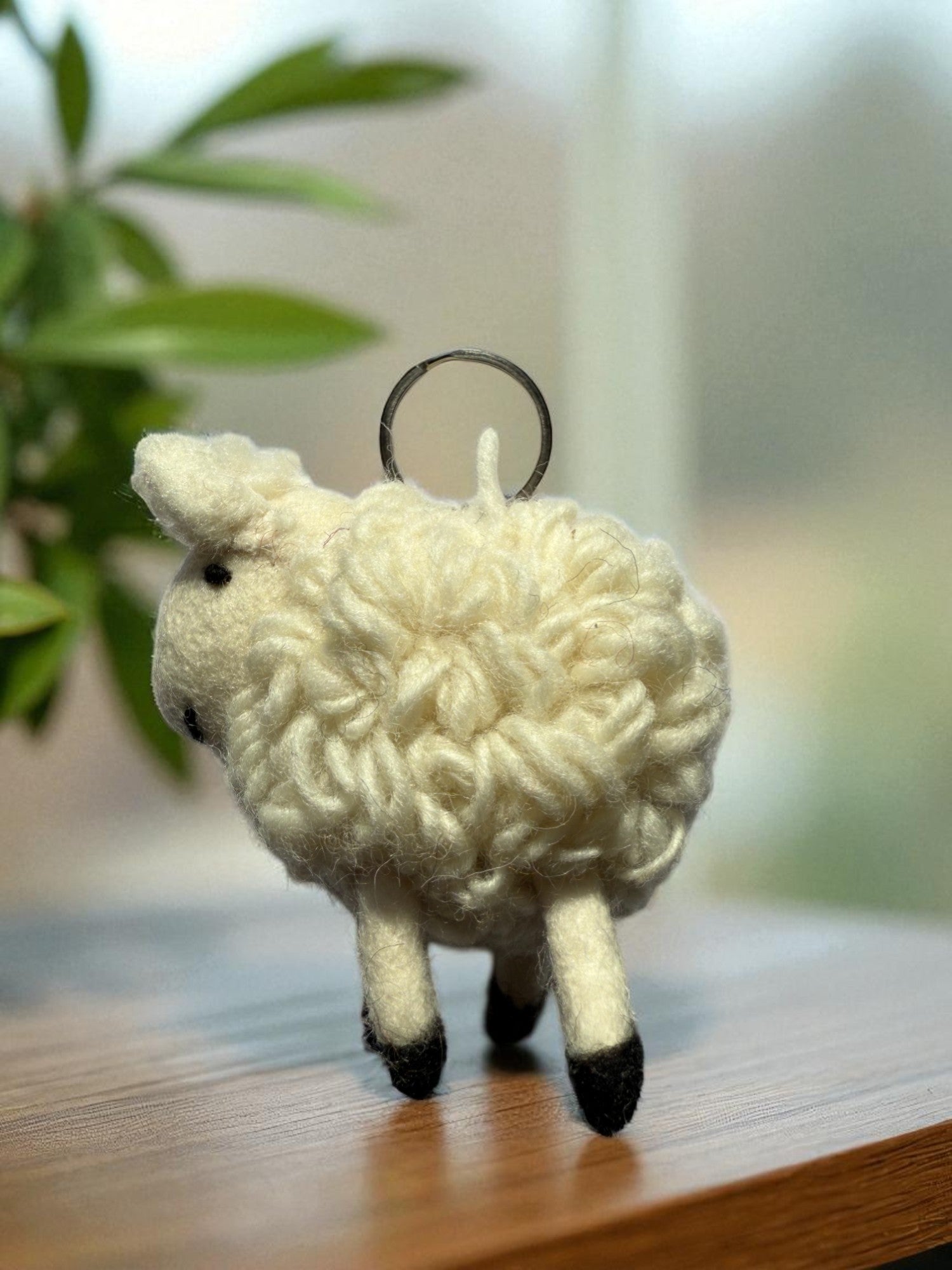 Handmade felt keychain featuring a sheep by artisans in Nepal, fair trade and eco-friendly