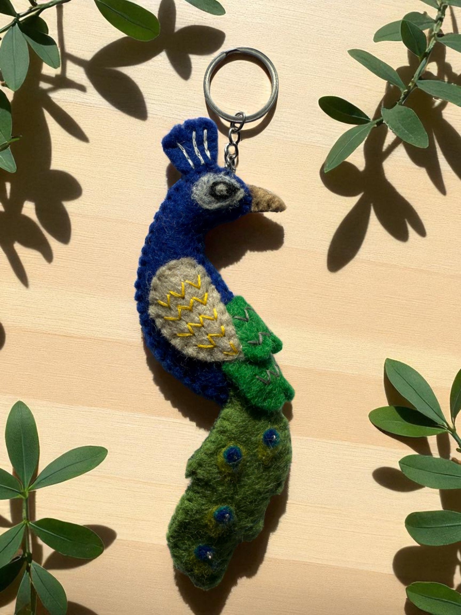 Handmade felt keychain featuring a peacock by artisans in Nepal, fair trade and eco-friendly