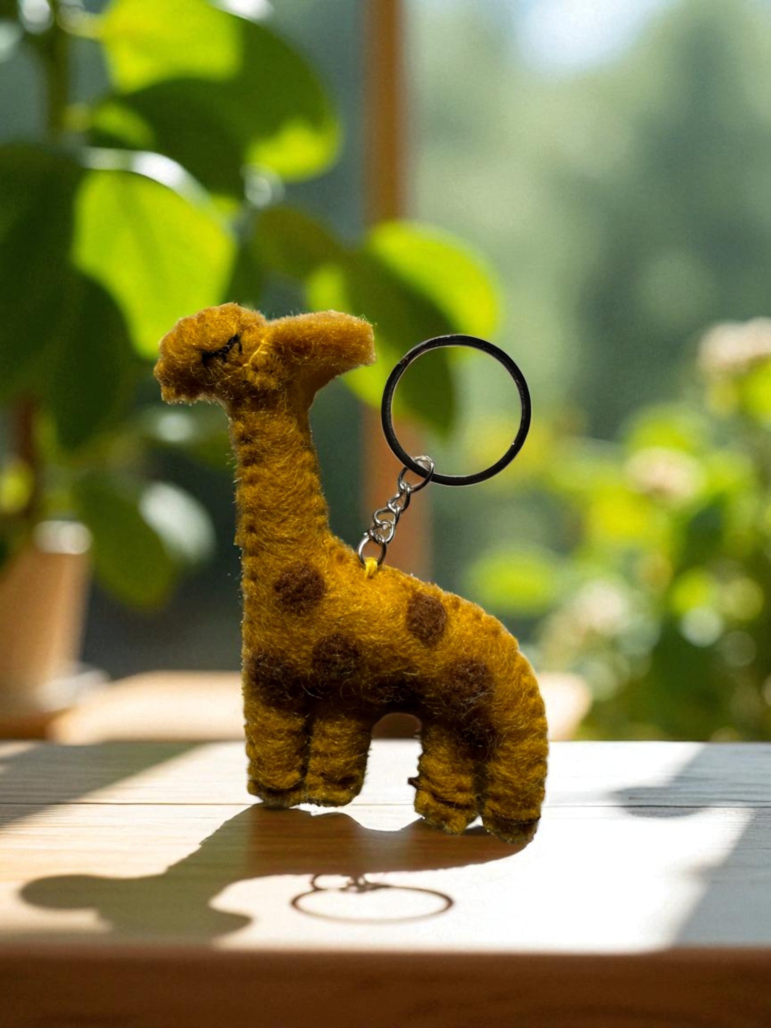 Handmade felt keychain featuring a giraffe by artisans in Nepal, fair trade and eco-friendly