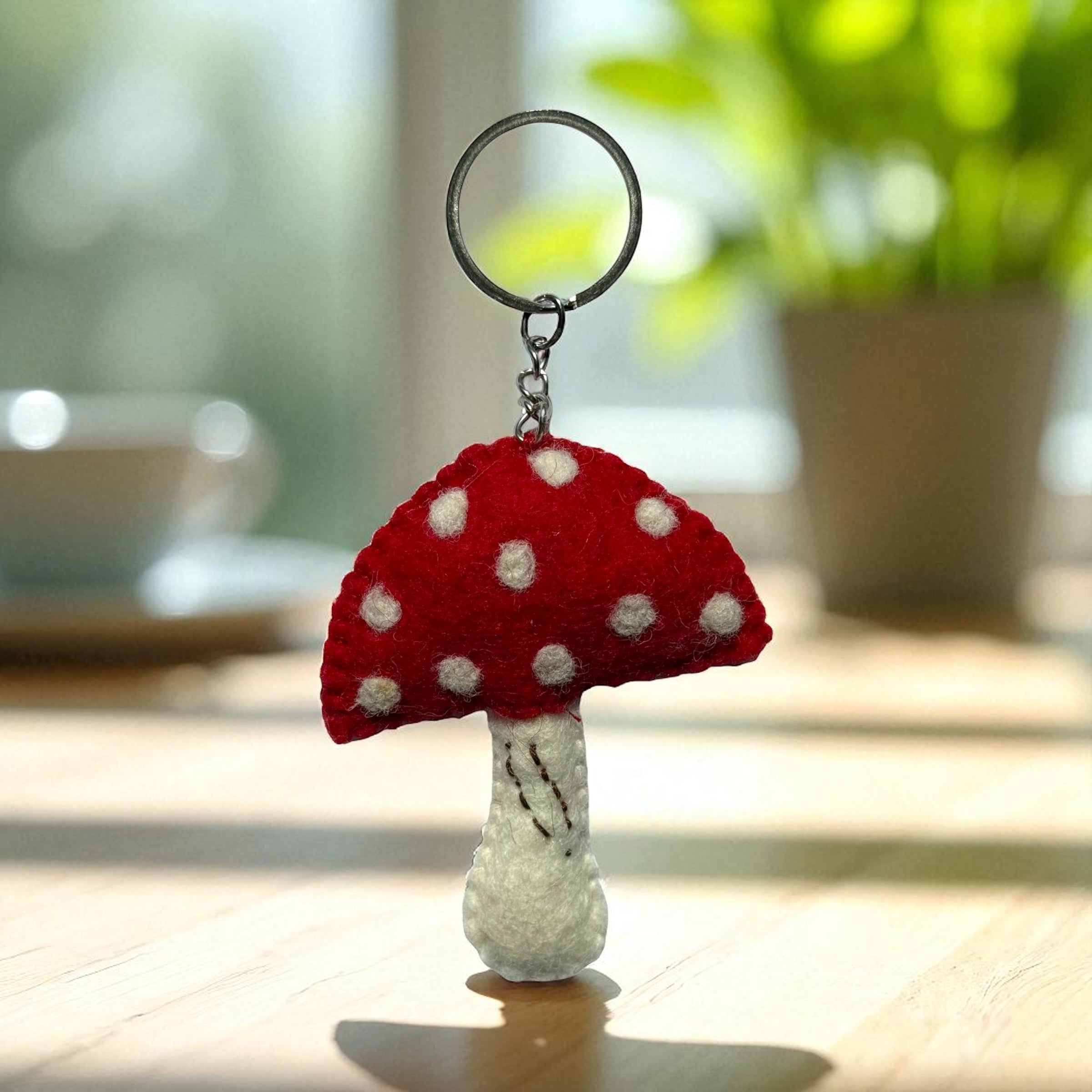 Handmade felt keychain featuring a mushroom by artisans in Nepal, fair trade and eco-friendly