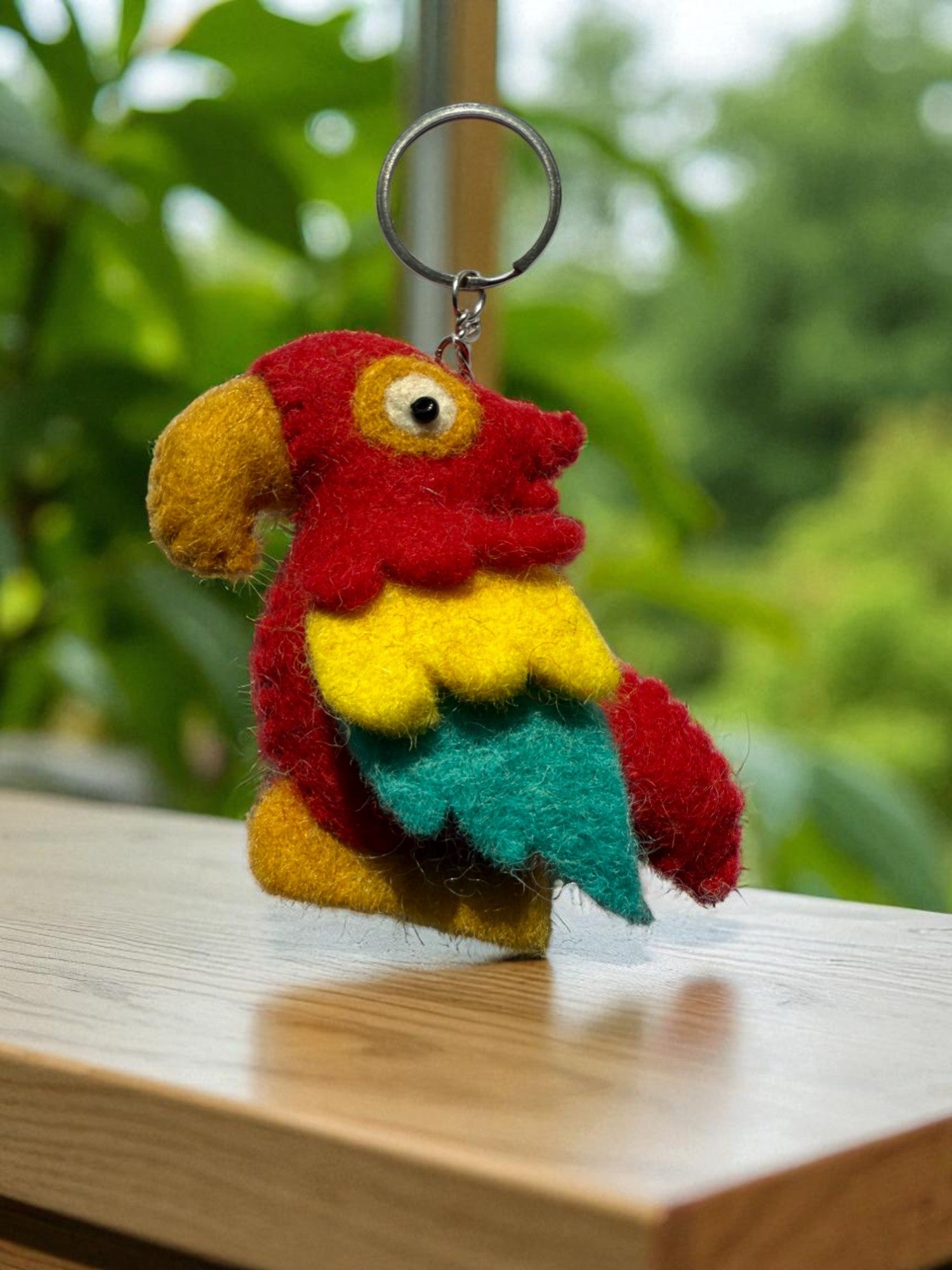 Handmade felt keychain featuring a parrot by artisans in Nepal, fair trade and eco-friendly