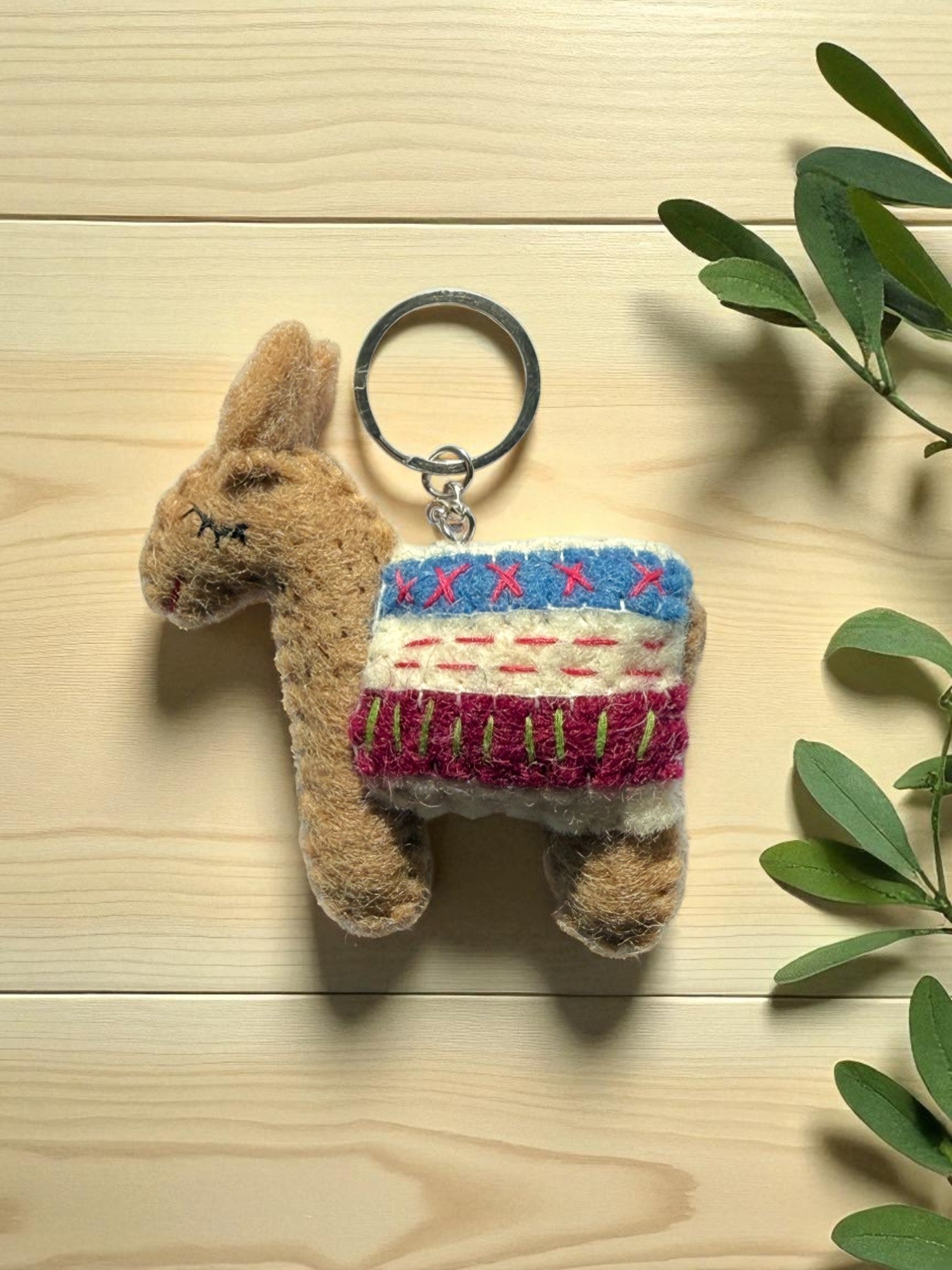 Handmade felt keychain featuring a brown lhama by artisans in Nepal, fair trade and eco-friendly