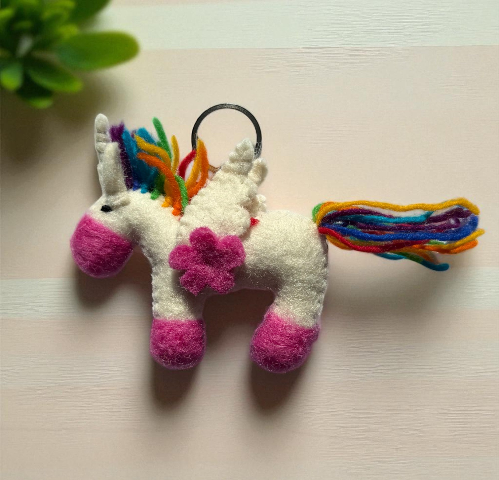 Handmade felt keychain featuring a unicorn by artisans in Nepal, fair trade and eco-friendly