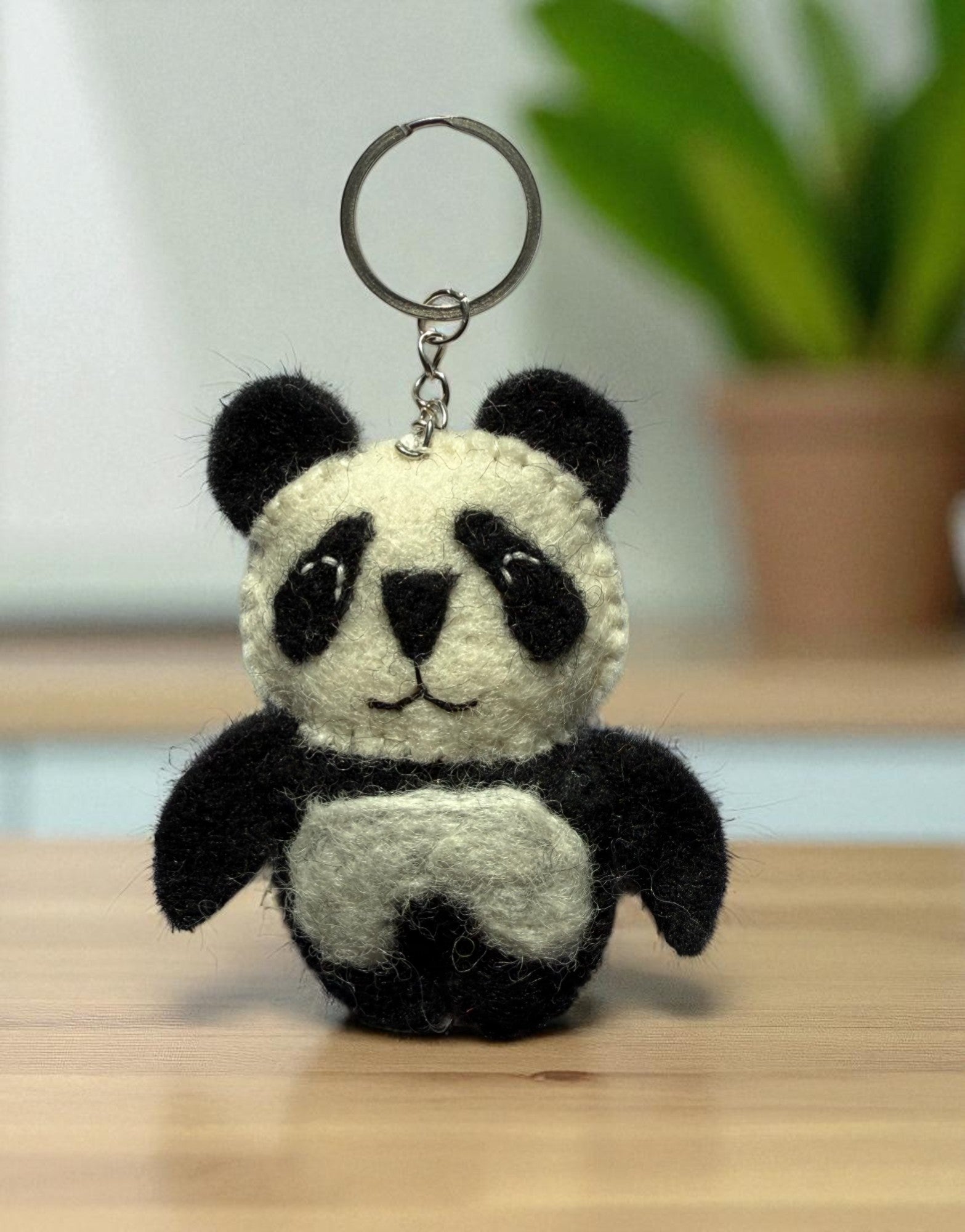 Handmade felt keychain featuring a panda by artisans in Nepal, fair trade and eco-friendly