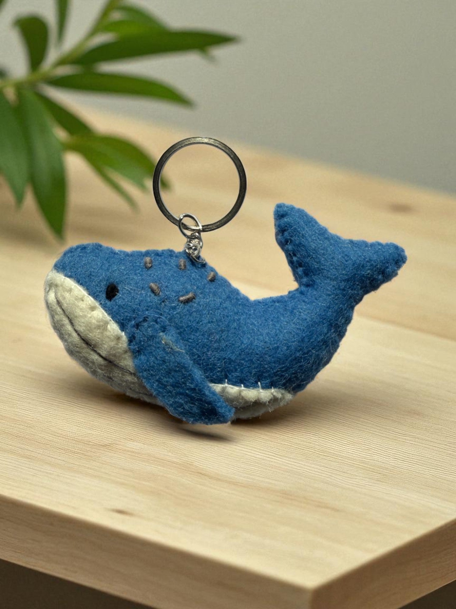 Handmade felt keychain featuring a blue whale by artisans in Nepal, fair trade and eco-friendly