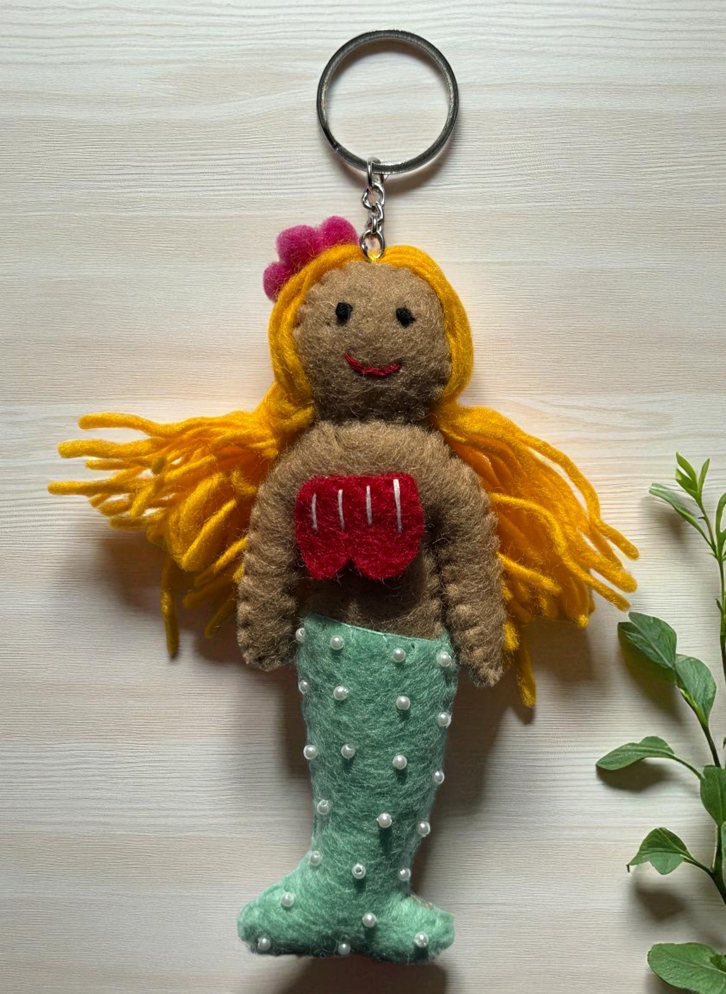 Handmade felt keychain featuring a blonde mermaid by artisans in Nepal, fair trade and eco-friendly
