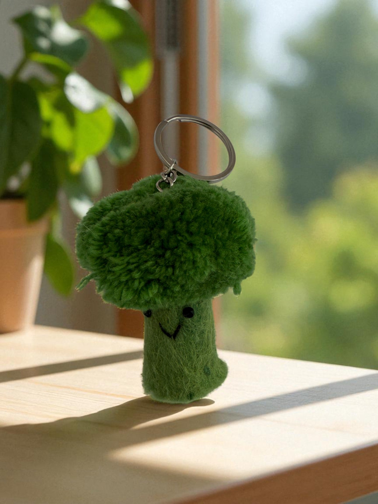 Handmade felt keychain featuring a brocolli crafted by artisans in Nepal, fair trade and eco-friendly