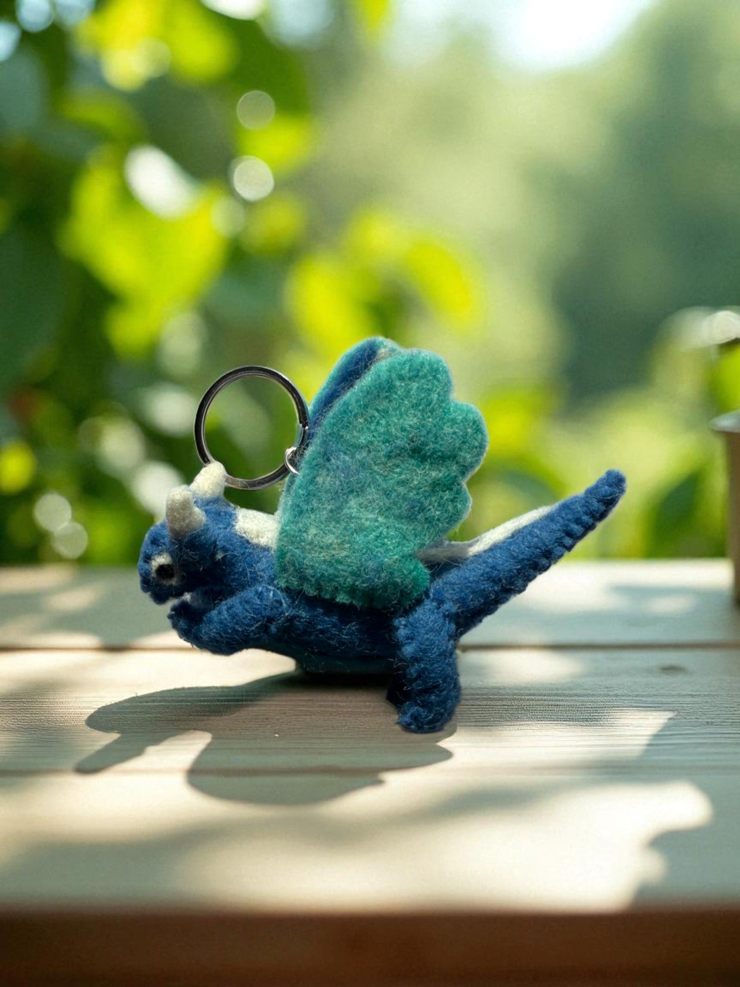 Handmade felt keychain featuring a blue dragon by artisans in Nepal, fair trade and eco-friendly