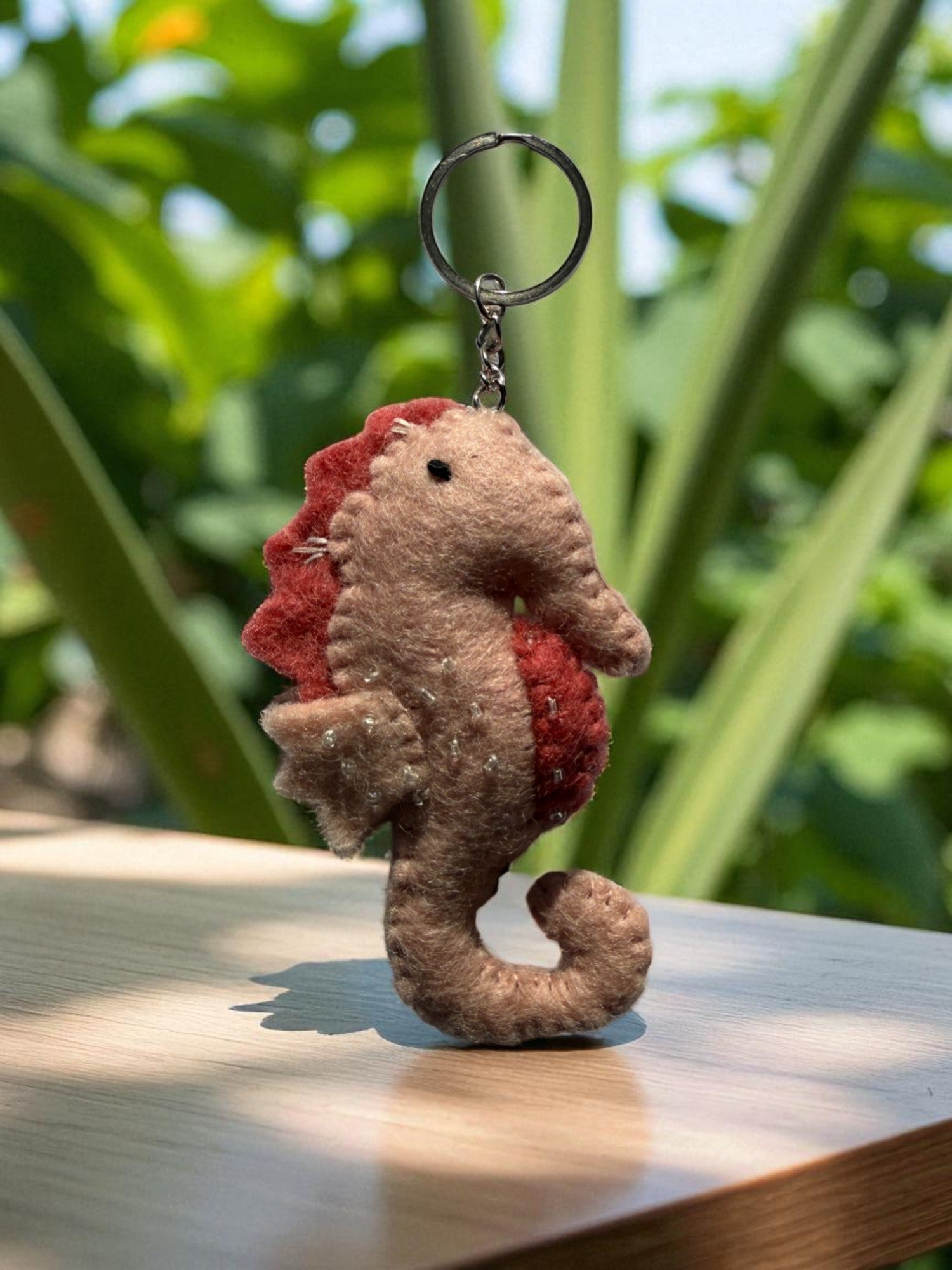 Handmade felt keychain featuring a seahorse by artisans in Nepal, fair trade and eco-friendly