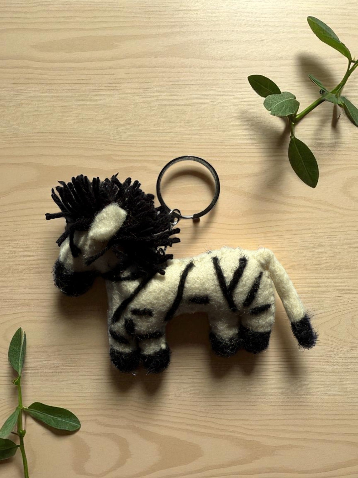 Handmade felt keychain featuring a zebra by artisans in Nepal, fair trade and eco-friendly