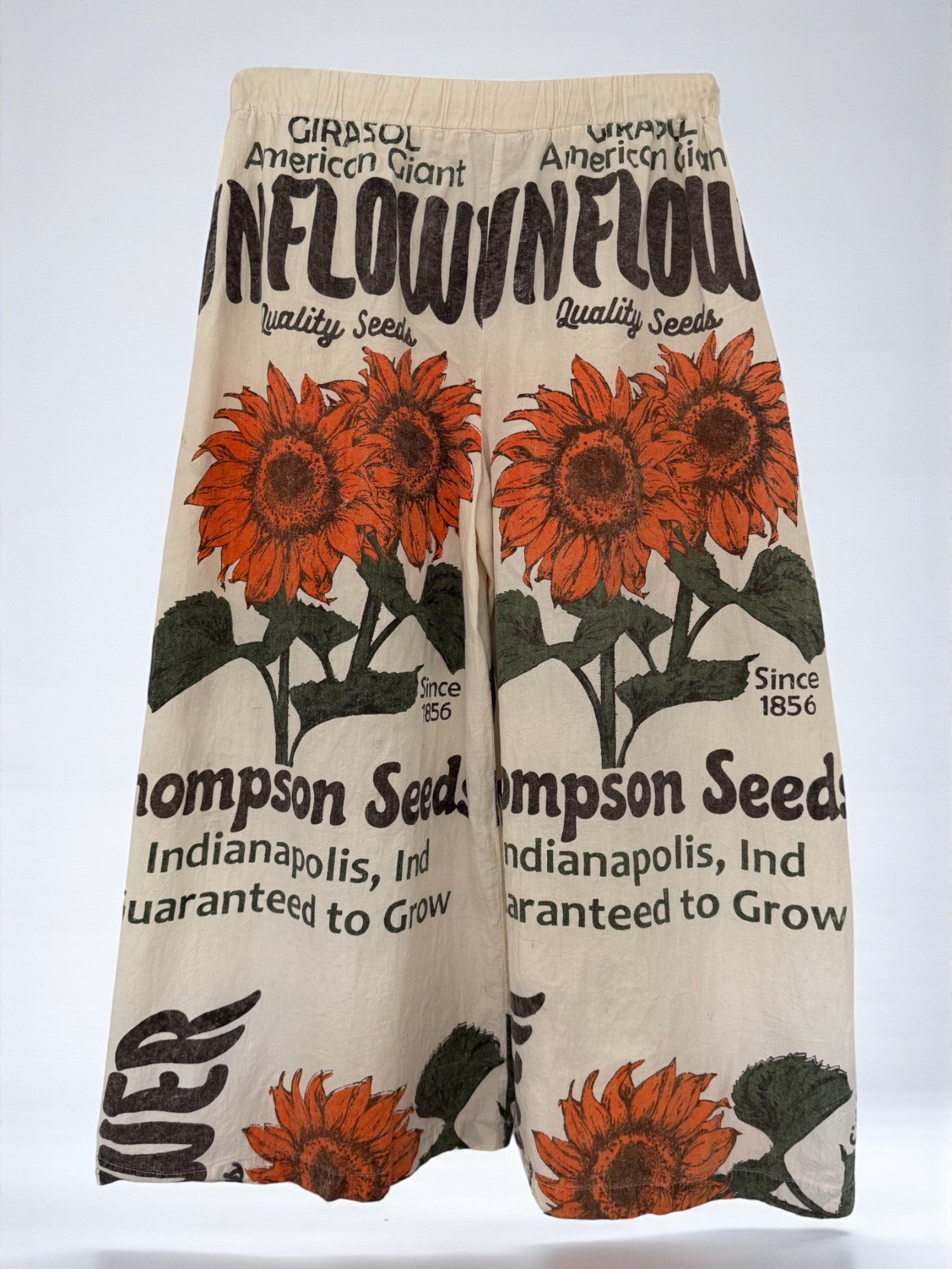 wide leg Pants with sunflower design and thompson seeds text