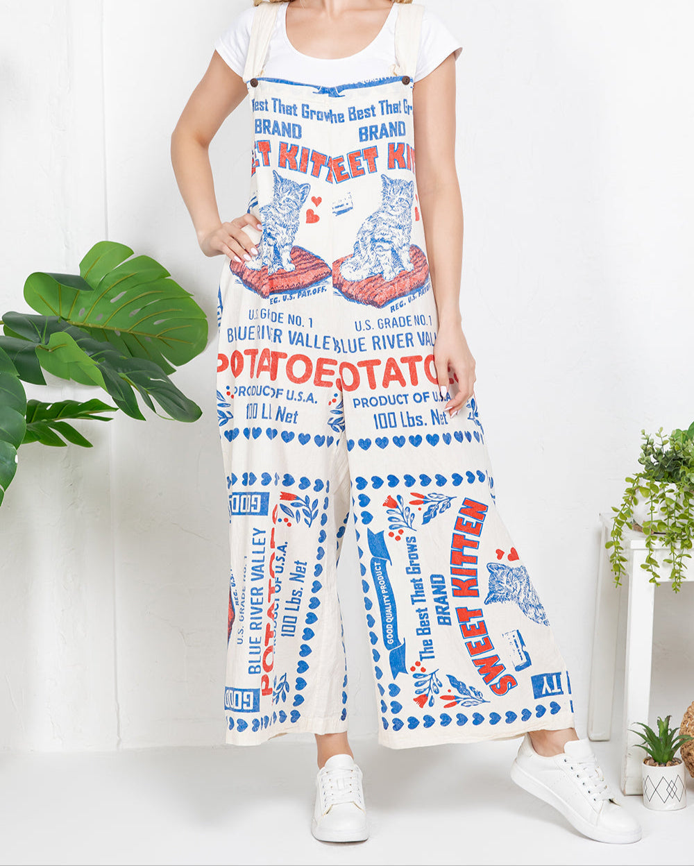 Vintage-inspired overalls with Sweet Kitten and Blue River Valley potato sack print, 100% cotton high-waisted trousers with retro red and blue typography graphics
