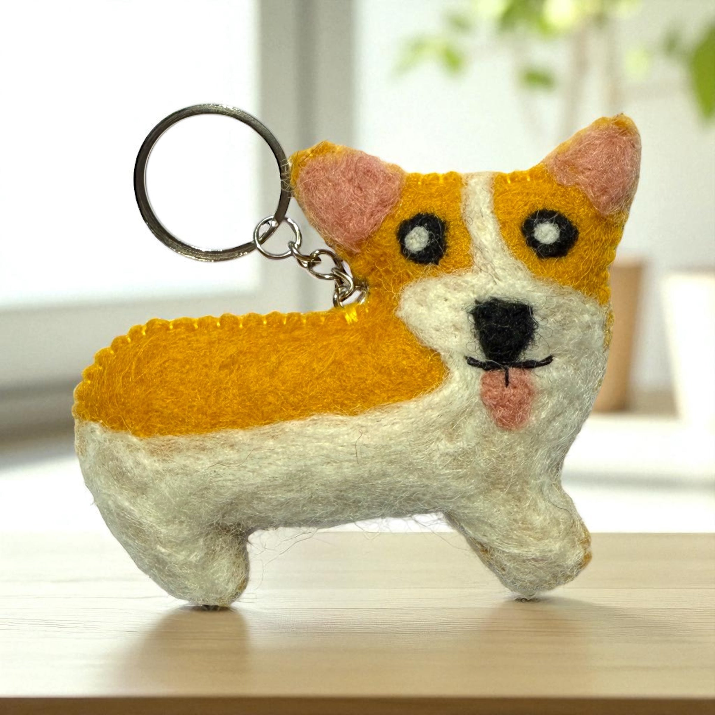 Handmade felt keychain featuring a corgi crafted by artisans in Nepal, fair trade and eco-friendly
