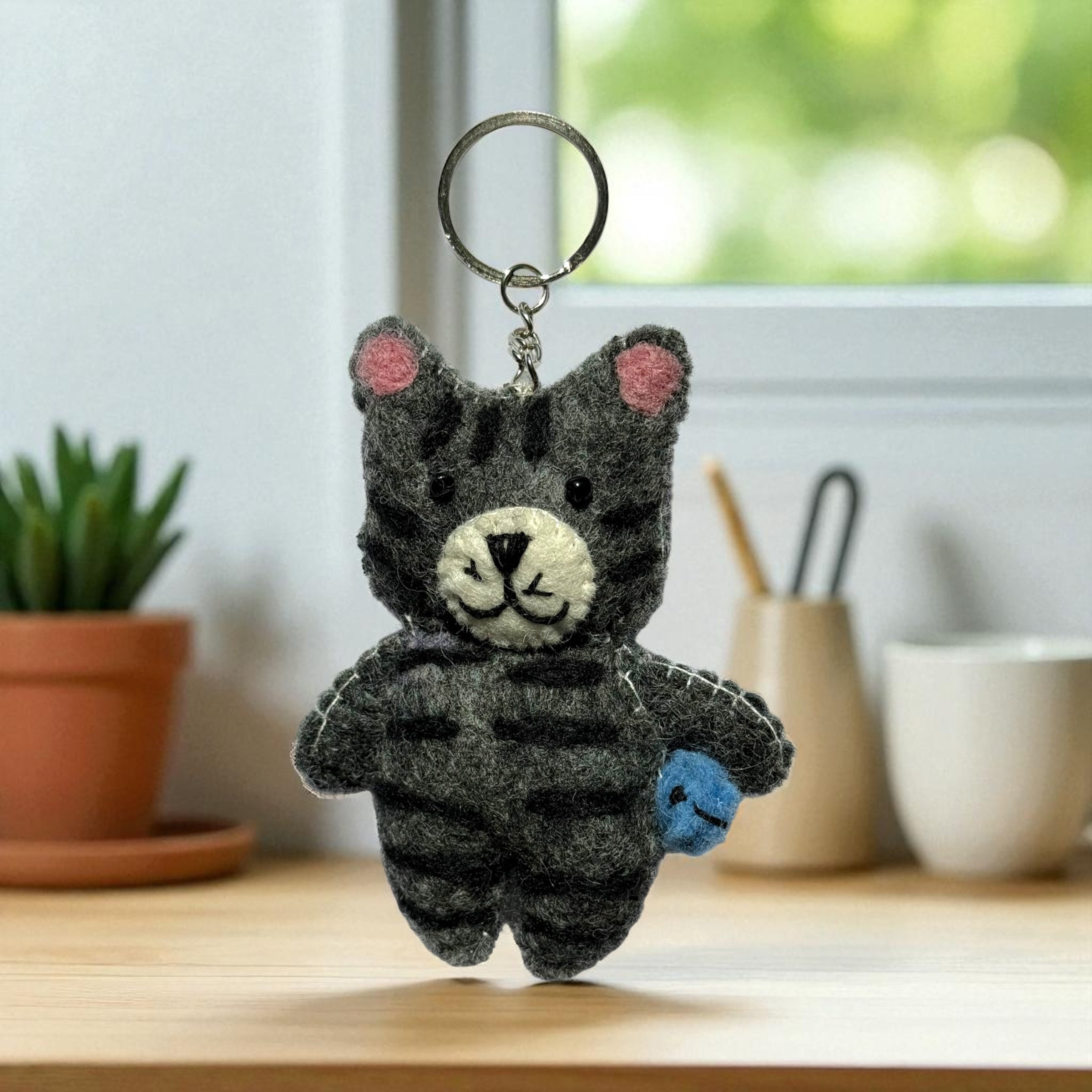 Handmade felt keychain featuring a cat with stripes crafted by artisans in Nepal, fair trade and eco-friendly