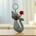 Handmade felt keychain featuring a gray cat wearing santa hat crafted by artisans in Nepal, fair trade and eco-friendly