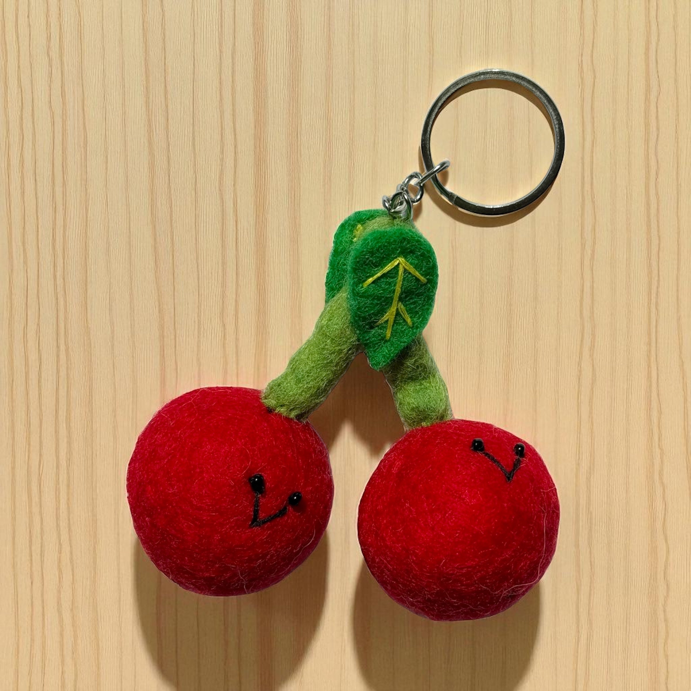 Handmade felt keychain featuring 2 cherries crafted by artisans in Nepal, fair trade and eco-friendly