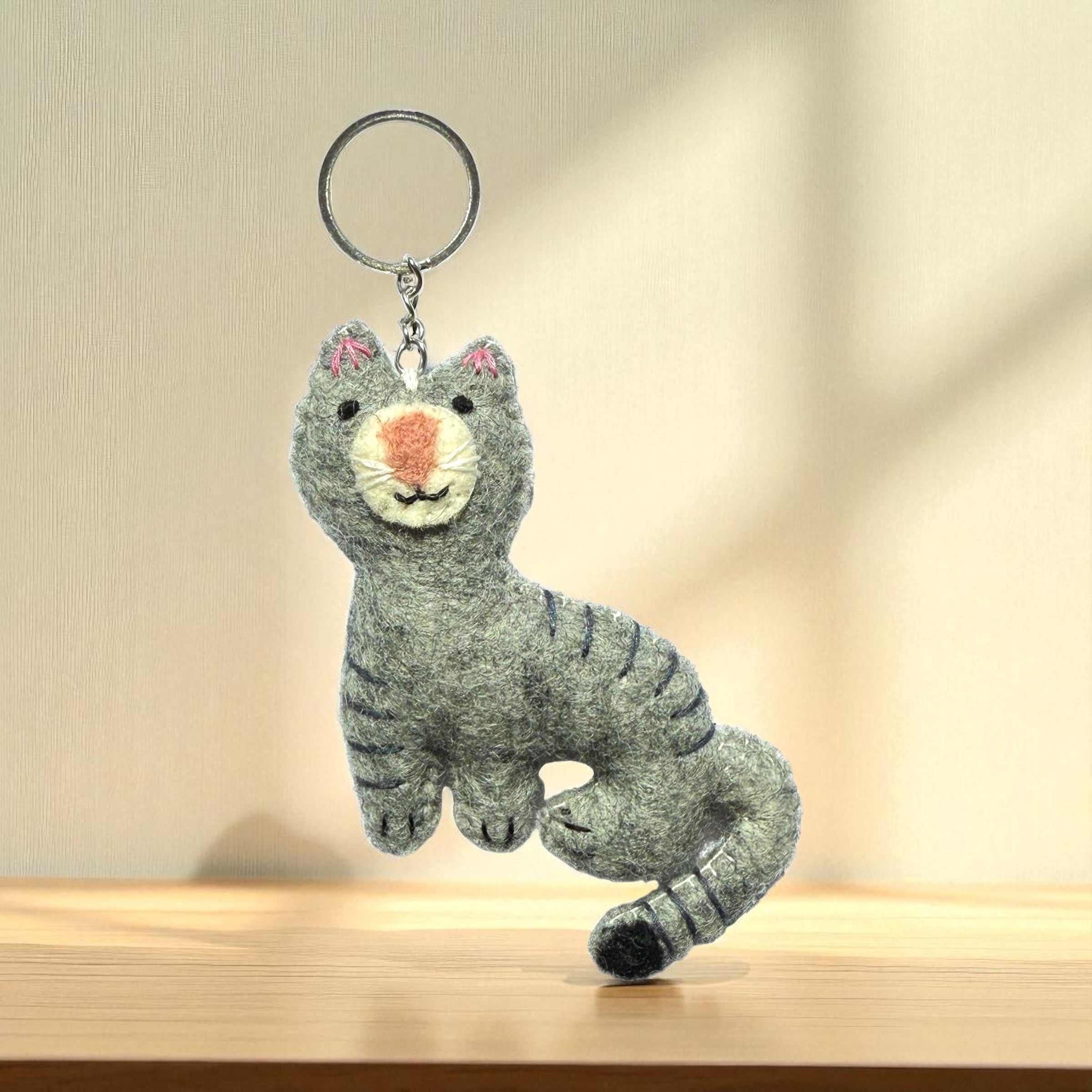 Handmade felt keychain featuring a gray cat crafted by artisans in Nepal, fair trade and eco-friendly