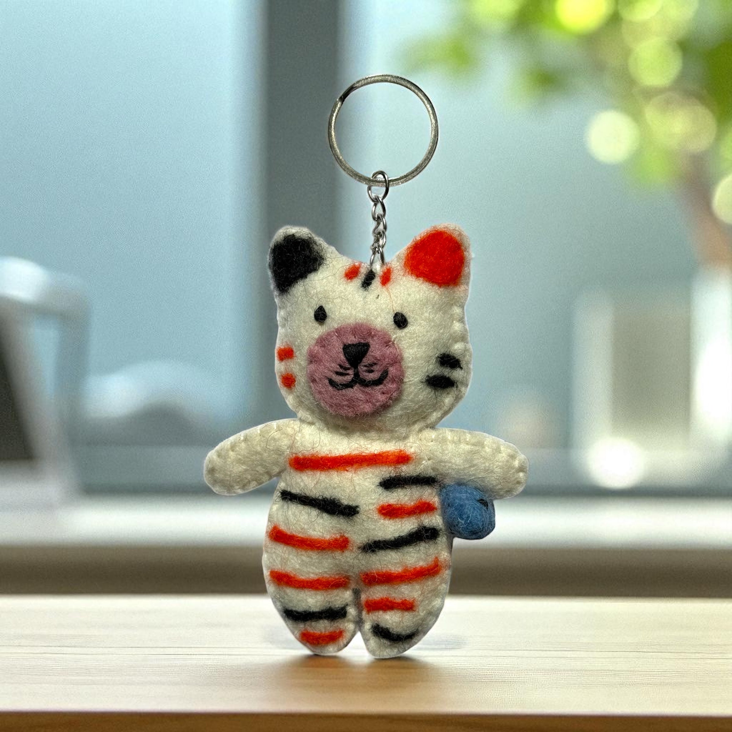 Handmade felt keychain featuring a cat with stripes crafted by artisans in Nepal, fair trade and eco-friendly