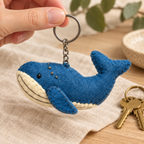 Handmade felt Blue Whale keychain shown in a lifestyle setting