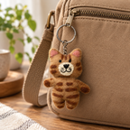 Handmade felt Brown Striped Paw keychain displayed on a bag