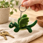 Handmade felt Green Dragon keychain shown in a lifestyle setting