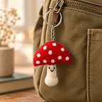 Handmade felt Mushroom keychain displayed on a bag