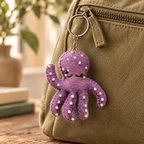 Handmade felt Octopus keychain displayed on a bag