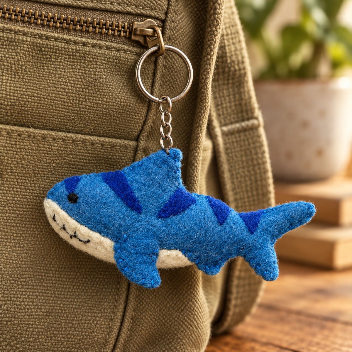 Handmade felt Shark keychain displayed on a bag