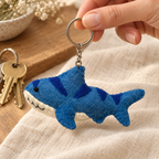 Handmade felt Shark keychain shown in a lifestyle setting